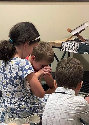 Children praying during catechesis