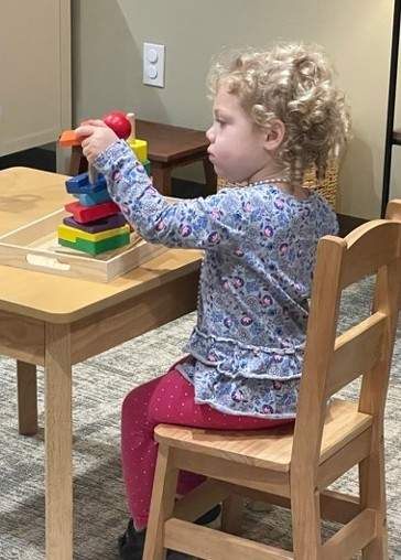 Little girl playing with building blocks